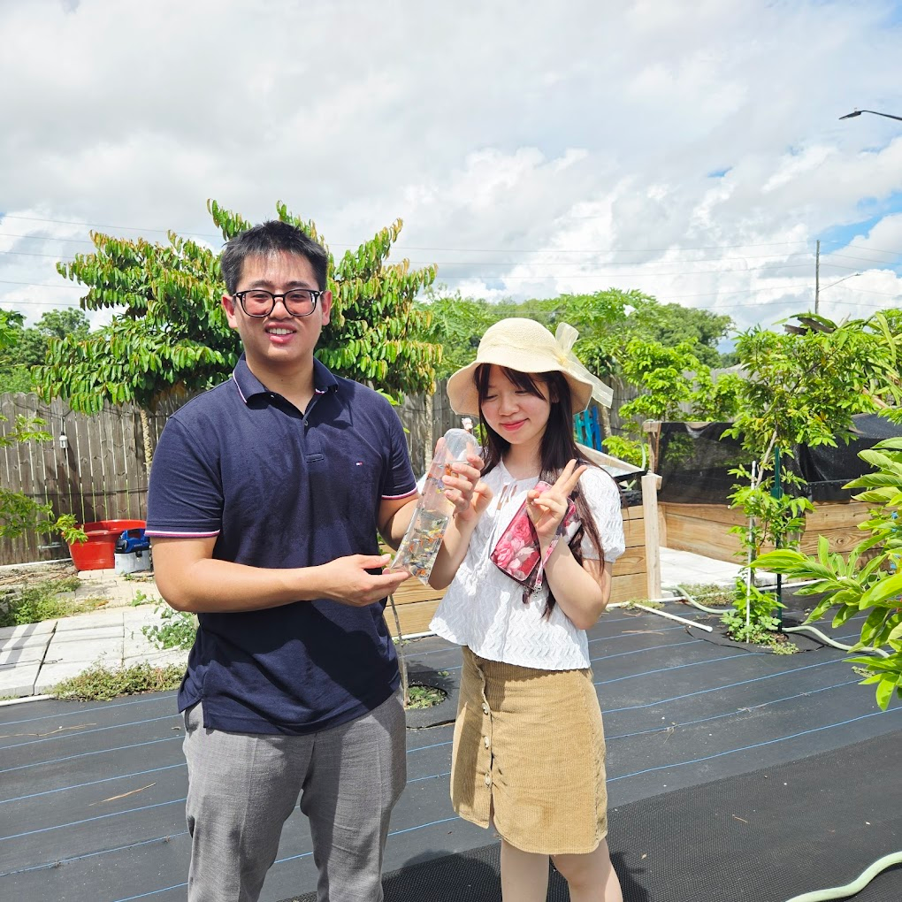 Couple visiting the farm with a bottle of guppies